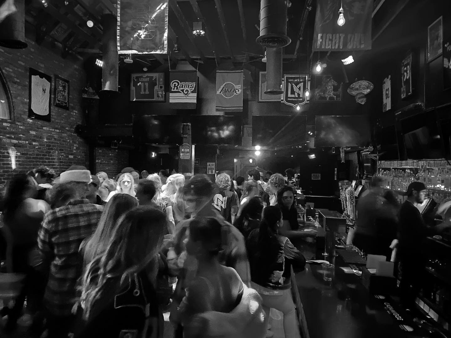 The room packed end to end in black and white, team banners hanging from the ceiling